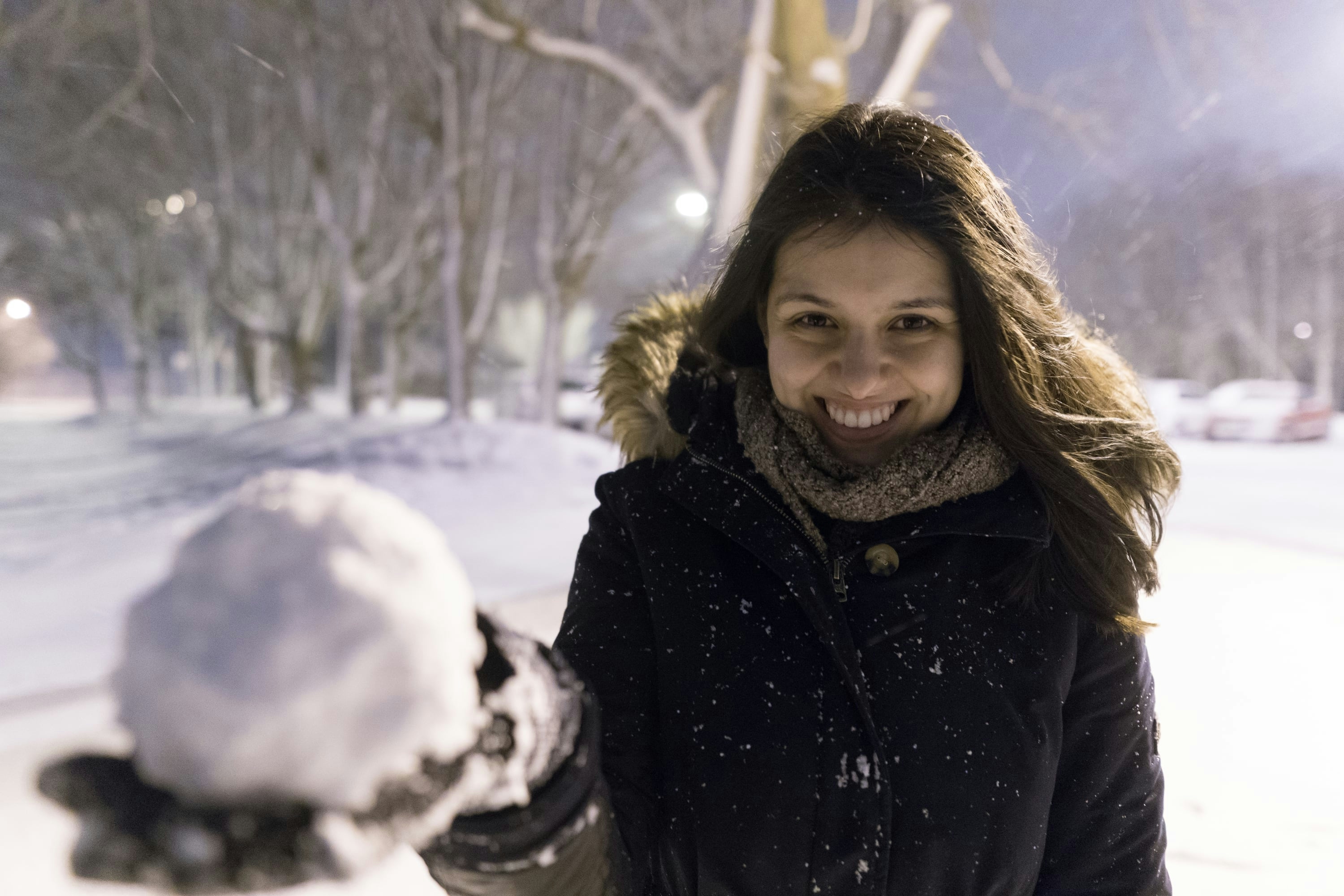 Laura holding a snowball and smiling