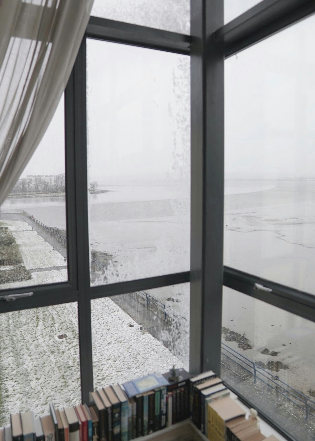 View from an apartment window, over an estuary covered in snow